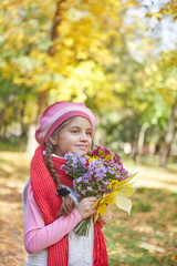 Beautiful happy girl in autumn park