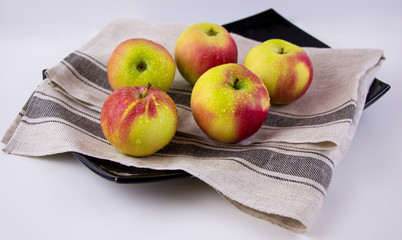 group of ripe red and yellow apples. juicy fruits on the plate.	