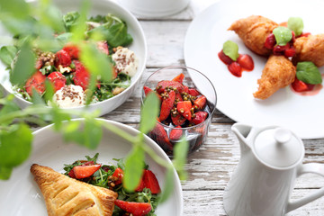 Strawberry dishes. Puff pastry with ricotta, arugula, curd and strawberry salad, strawberries in balsamic vinegar with green pepper, strawberry pancakes