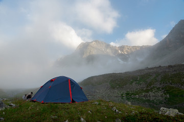 Tourist tent on a background of cloud or fog near the mountain Dzhalkaush, Teberda, Karachay-Cherkess Republic, Russia