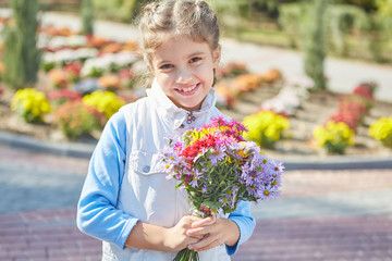 Beautiful happy girl in autumn park