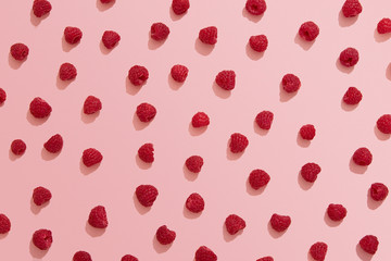 Raspberries on pink background, berry flat lay