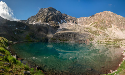 Fototapeta premium Alpine lake with clear water near the mountain Dzhalkaush, Teberda, Karachay-Cherkess Republic, Russia