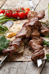beef skewers on a wooden table, selective focus