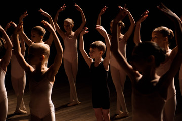 A large group of children rehearsing and dancing the ballet