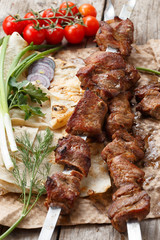 beef skewers on a wooden table, selective focus