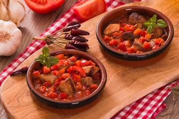 Marinated pork loin in tomato sauce.