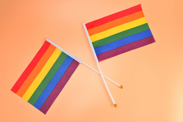 LGBT flag on orange background. Copy space.