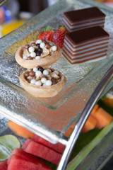 Various desserts with fresh fruits on buffet line