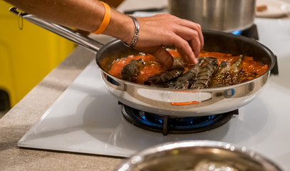 Delicious Tiger Prawns or Shrimps in tomato sauce and herbs on a pan. Italian cuisine.