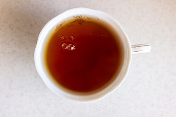 Cup of tea on a wood table, top view. A Cup of tea top view. Glass of tea top view on white surface