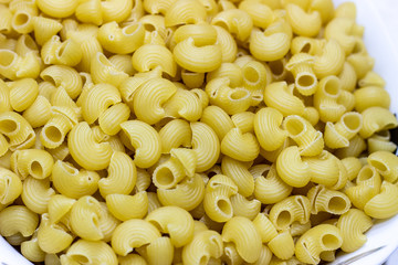 Macaroni pasta background. A container of pasta. Yellow pasta