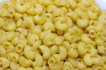 Macaroni pasta background. A container of pasta. Yellow pasta