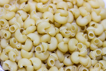 Macaroni pasta background. A container of pasta. Yellow pasta