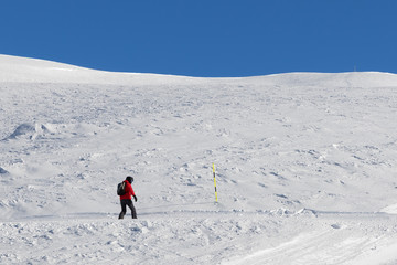 Snowboarder downhill on snowy slope