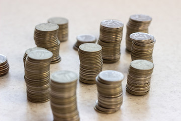 russian coins of white and yellow metal on wooden surface at sunny day. Metallic rubles on a white surface. Russian money on a white surface. Russian metal money. Russian metal rubles