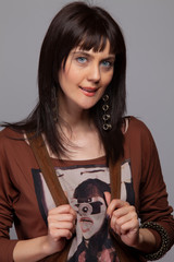 Portrait of a beautiful girl with a shy smile isolated on gray background 