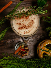 Brown cocktail in a glass goblet on a long leg. In the tropical garden. On a flat stone.