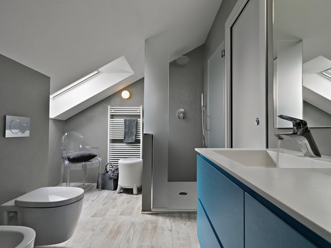 interior of modern bathroom with blue furniture  and masonry shower cubicle