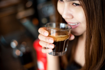 Beautiful asian woman is drinking coffee