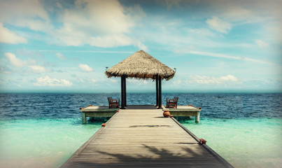Pier of coral island in paradise island in Indian ocean.