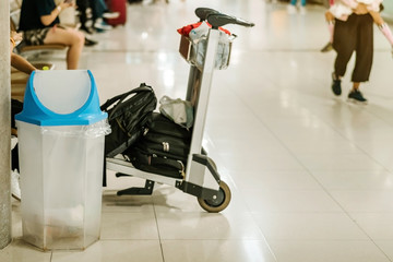 Fototapeta premium Blue cover transparent trashcan for increasing safety measures placed on the floor in the airport.