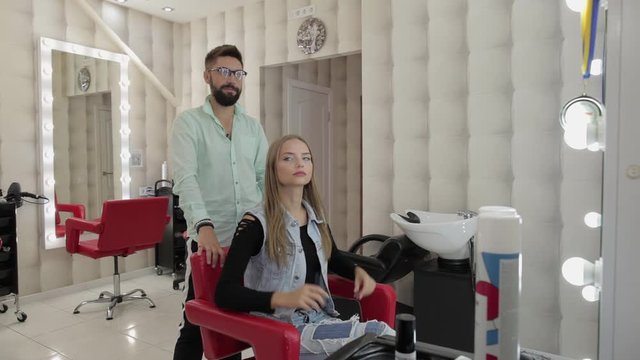 Professional styling. Beautiful woman sit in chair and ready for new haircut