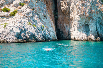 Seascape view to turquoise waters of Aegean Sea in Island Moni near Athens, blue caves.