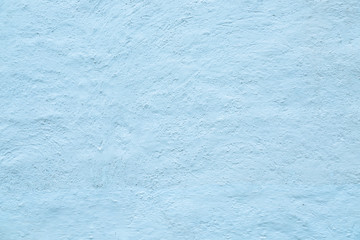 Texture of white stone whitewashed and plastered old wall. Image is tinted in blue light.