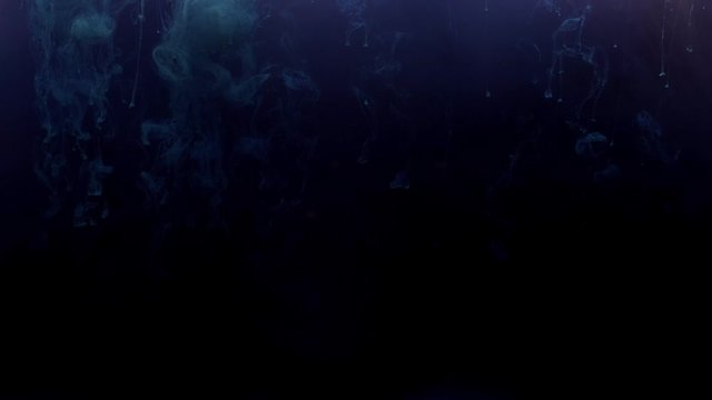 Blue ink drops from above mixing in dark water, swirling softly underwater on black background. Colored acrylic cloud of paint isolated. Abstract smoke explosion animation. 4K footage.