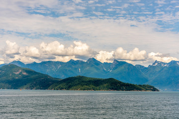 View at mountains in British Columbia, Canada.View over Inlet, ocean and island with mountains in beautiful British Columbia. Canada.