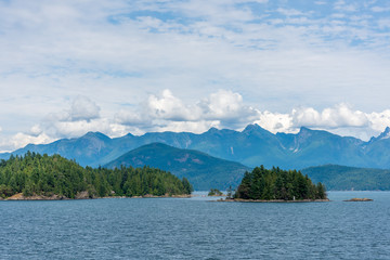 View at mountains in British Columbia, Canada.View over Inlet, ocean and island with mountains in beautiful British Columbia. Canada.
