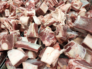 Frozen meat cut into cubes and slices and allowed to melt on the table. Display for sale in the supermarket. 