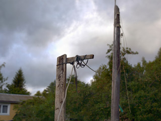 old wooden electric pole and sagged wires