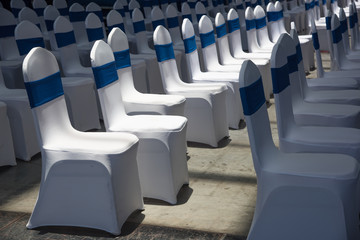 Sunlight illuminates indoor multi-row white business meeting seats