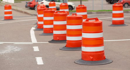 long line of orange traffic barrier barrels