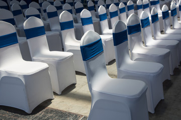 Sunlight illuminates indoor multi-row white business meeting seats