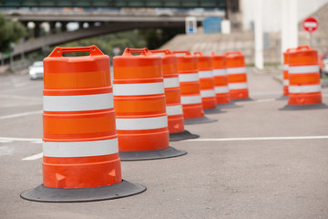 long line of orange traffic barrier barrels to detour traffic