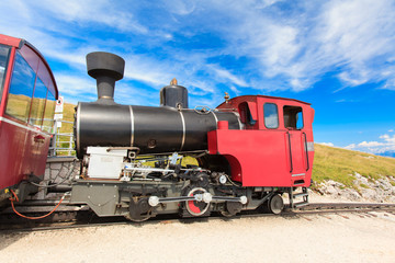 Fototapeta na wymiar Steam train in a beautiful alpine landscape.