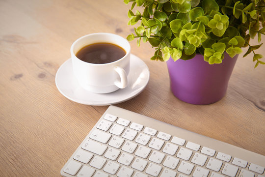 on the desktop computer and a cup of coffee