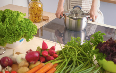 Young Woman Cooking in the kitchen. Healthy Food