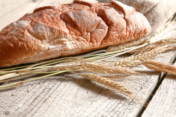 Freshly baked traditional bread on wooden table