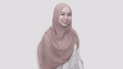 portrait of asian muslim woman with head scarf inside room indoors posing to camera