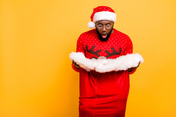 Portrait of his he nice attractive worried guy holding in hands looking big large red sack December wish packages dream isolated over bright vivid shine yellow background