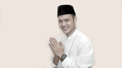 Portrait of cheerful young muslim man smiling in front of camera