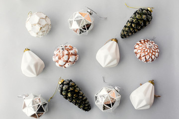 Christmas vintage ornaments on grey paper, flat lay. Stylish vintage glass baubles and pine cones,...