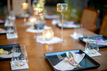 Dinner set on the wood table with long wine glass