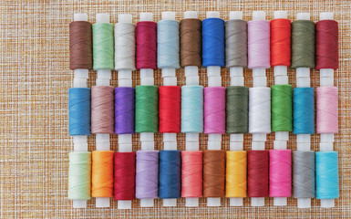 Multicolored sewing threads. Spools of thread for sewing. The concept of sewing accessories.