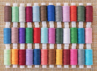 Multicolored sewing threads. Spools of thread for sewing. The concept of sewing accessories.