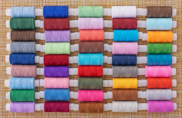 Multicolored sewing threads. Spools of thread for sewing. The concept of sewing accessories.